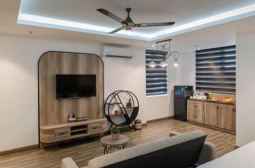 a living room with a tv and a couch at Aaron Boutique Hotel in Nha Trang