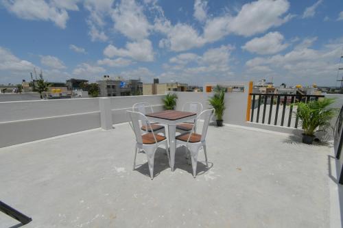 a table and chairs sitting on a roof at HomeSlice Manzil - 1BHK in HSR in Bangalore
