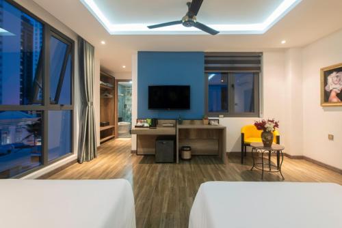a hotel room with a bed and a tv at Aaron Boutique Hotel in Nha Trang