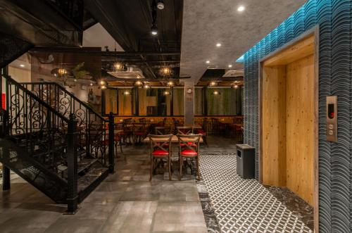 a restaurant with chairs and tables in a room at Aaron Boutique Hotel in Nha Trang