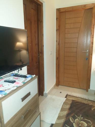 a living room with a television and a door at مكادى هايتس in Hurghada