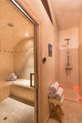 La salle de bains est pourvue d'une douche, d'une baignoire et de serviettes. dans l'établissement La Bastide De Tourtour Hotel & Spa, à Tourtour