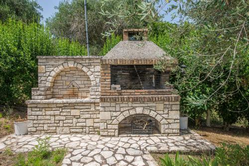 an outdoor brick oven in a yard at Villa Areti in Astrakeri