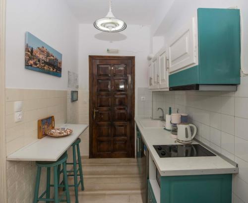 a kitchen with green cabinets and a counter top at Villa Areti in Astrakeri