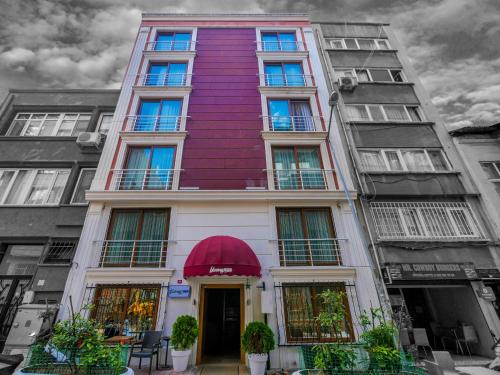 a tallartment building with a purple building at Blueway Hotel Residence in Istanbul