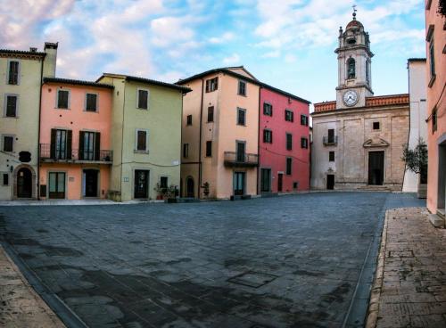 an empty street in a town with a clock tower at Radius Horse Ranch B&B in Massa Martana