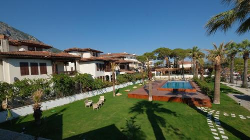 an image of a resort yard with a swimming pool at Marina Port Akyaka in Muğla