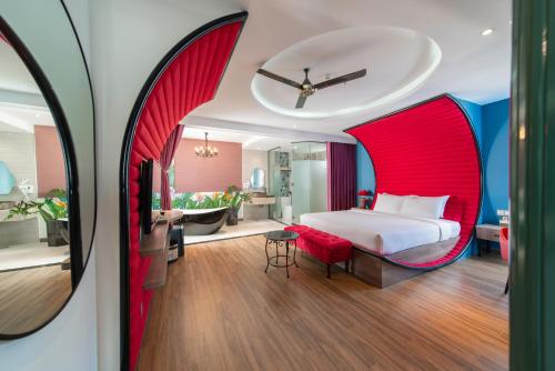 a hotel room with a bed with red curtains at Aaron Boutique Hotel in Nha Trang