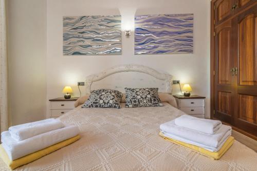 a bedroom with a large bed with two pillows at Can Berguins in Búger