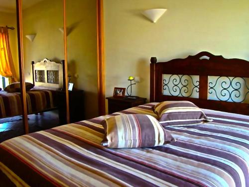 a bedroom with a bed with two pillows on it at Bella & Gordinho GuestHouse in Lagos