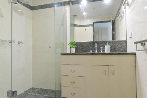 a bathroom with a shower and a sink at Great Location! Darling Harbour Superb 2BR Apt in Sydney