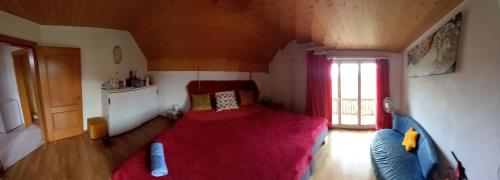 a bedroom with a large red bed in a room at 1 Zimmer in Kestenholz in Kestenholz