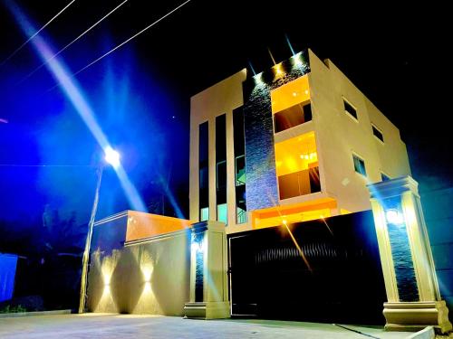 a building with a street light in front of it at night at Kemc apartment in Ashalebotwe