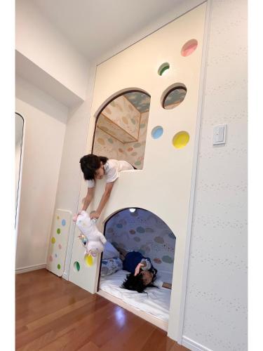 two children playing in a play bed in a play room at Coral Gate in Kume コーラルゲートイン久米 in Naha