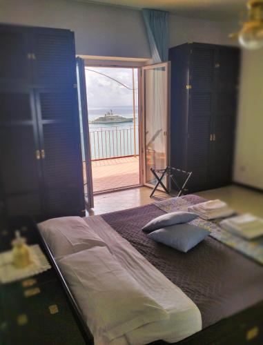 a bedroom with a bed with a view of the ocean at Villa Paradise (Amalfi Coast - Luxury Home - Beach) in Vietri sul Mare
