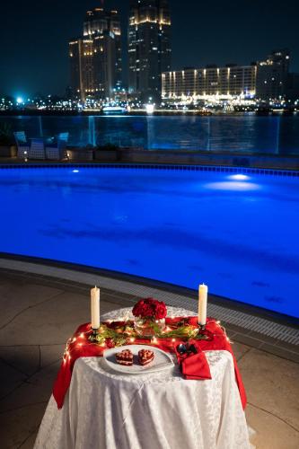 a table with lights on it with a view of the city at Hilton Cairo Zamalek Residences in Cairo