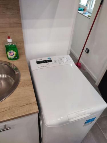 a white refrigerator in a kitchen with a sink at studio proche du marché de Noël de Strasbourg in Schiltigheim