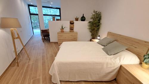 a bedroom with a large bed in a room at Mi Casita De Garraf in Garraf