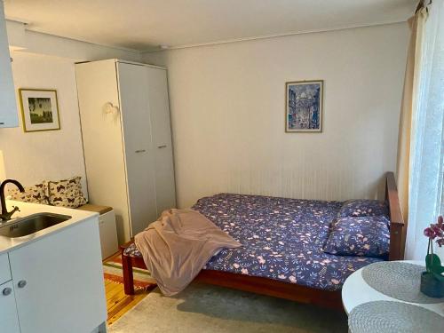 a small bedroom with a bed and a sink at 42 Juhkentali in Tallinn