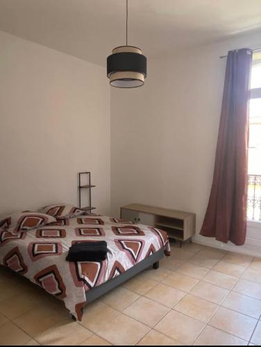une chambre avec un lit et une grande fenêtre dans l'établissement Liberté 2 -Spacieux Appartement proche Polygone et centre ville - Beziers - Wifi - Tv Connecté, à Béziers