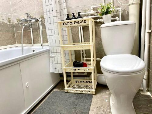 ein Badezimmer mit einem WC und einer Badewanne in der Unterkunft Уютная однушка в центре города in Temirtaū