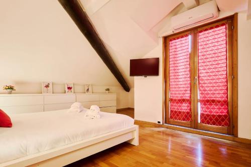 a bedroom with a white bed and a window at Moscova Charme Apartment in Milan