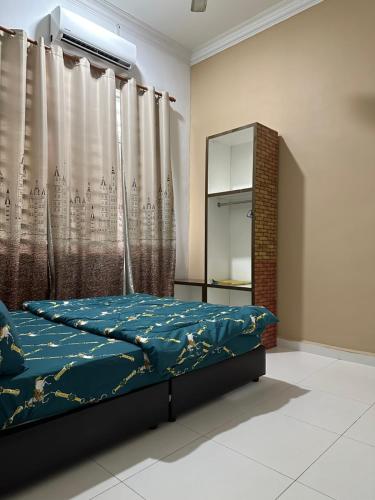 a bedroom with a bed and a mirror and curtains at Zuriana Ashraf Homestay Kota Bharu in Kota Bharu