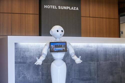 a robot holding a cell phone in its hands at Hotel Sunplaza in Osaka