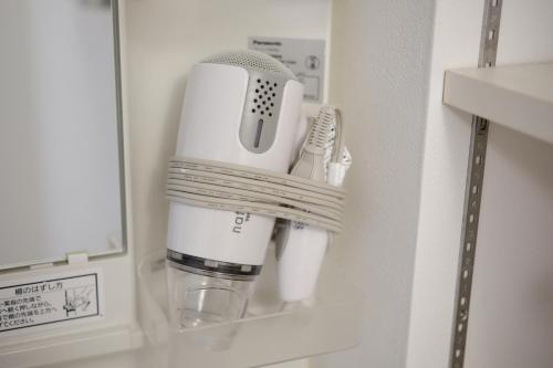 a coffee maker in a cup holder in a bathroom at Coral Gate in Kume コーラルゲートイン久米 in Naha
