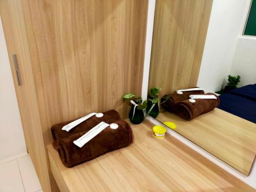 two brown bags on the floor next to a door at Homestay Manitha in Seri Manjung