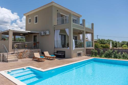 a villa with a swimming pool and a house at Aleli Villas with Tennis Court in Minia