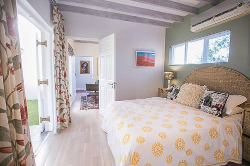 a bedroom with a large bed and a window at Delightful db story loft with airconditioning in Hermanus