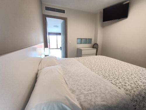 a bedroom with a large white bed and a television at Rey Mundo in Munébrega