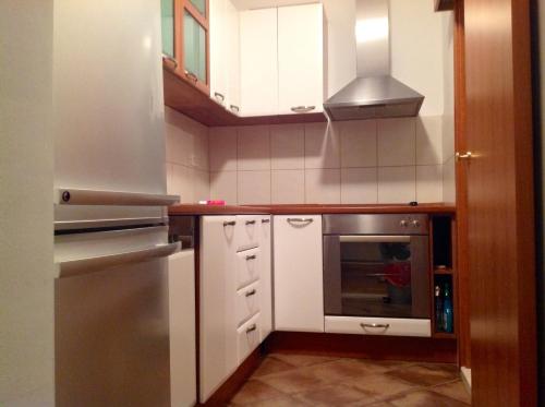 een keuken met witte kasten en een roestvrijstalen apparaat bij Apartment Biserka in Cavtat