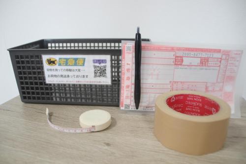 a desk with a keyboard and a pen and books at Coral Gate in Kume コーラルゲートイン久米 in Naha