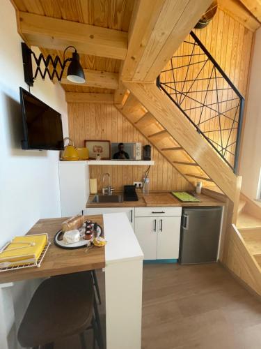 a kitchen with white cabinets and a wooden ceiling at Dona Irene AL in Manteigas