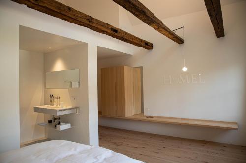 a bedroom with a bed and a sink in a room at BAR10ZIMMER in Dornbirn