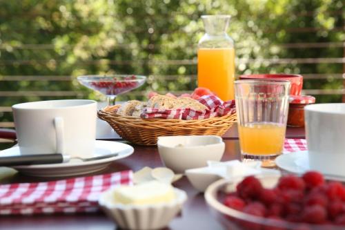 a table with a breakfast of bread and orange juice at Casa Agricola da Levada Eco Village in Vila Real