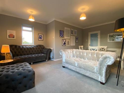 a living room with two couches and a couch at Stylish Apartment walk to train 