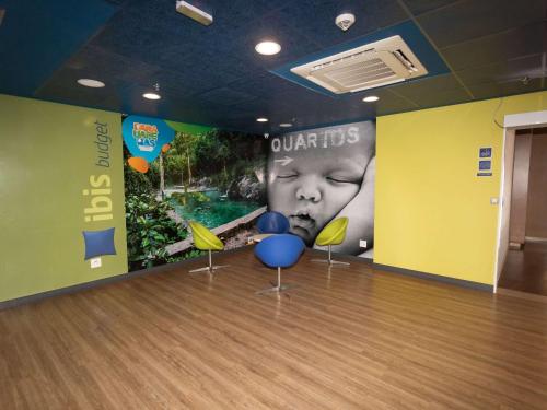 a bowling alley with chairs and a poster of a child at ibis budget Parauapebas in Parauapebas