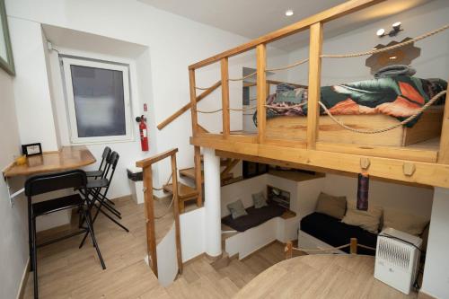a small room with a bunk bed and a desk at LOFT Studio in Central Lisbon in Lisbon
