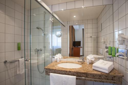 a bathroom with a sink and a shower at Best Western Hotel Am Straßberger Tor in Plauen