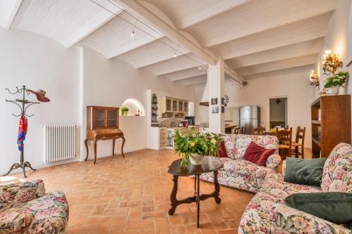 a living room with couches and a table at Tenuta di Megognano in Poggibonsi