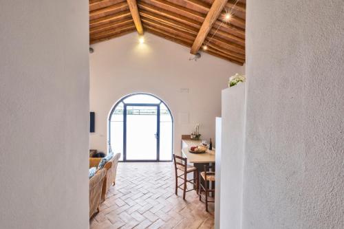 a kitchen and living room with a table and chairs at Tenuta di Megognano in Poggibonsi