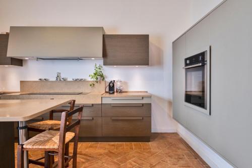 a kitchen with a table and chairs and a counter at Tenuta di Megognano in Poggibonsi