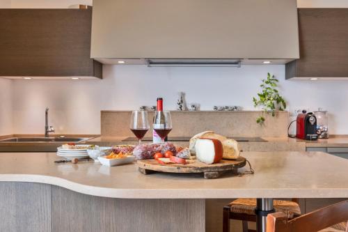 a kitchen counter with a tray of food and glasses of wine at Tenuta di Megognano in Poggibonsi