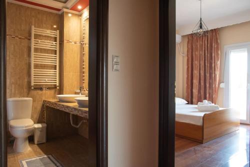 a bathroom with a bed and a toilet and a sink at 3 bedrooms luxury apartment in Nea Iraklia