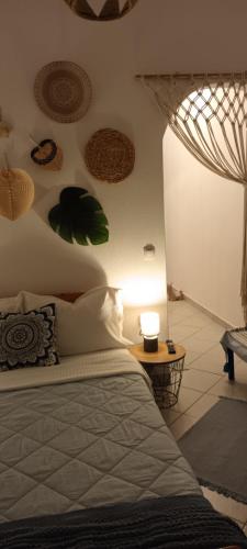 a bedroom with a bed and a table with a lamp at Mana mia Seaside Apartments in Leptokaria