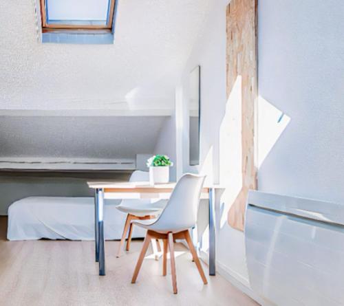 a dining room with a table and a chair at Bright Studio in the heart of Lyon in Villeurbanne