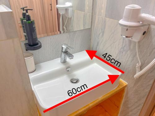 a bathroom sink with aethaan sign on it at Hotel Aurora in Băile Olăneşti
